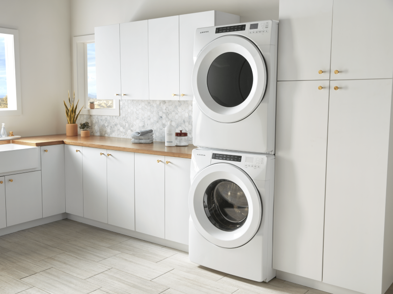 White stacked front loading washer and dryer