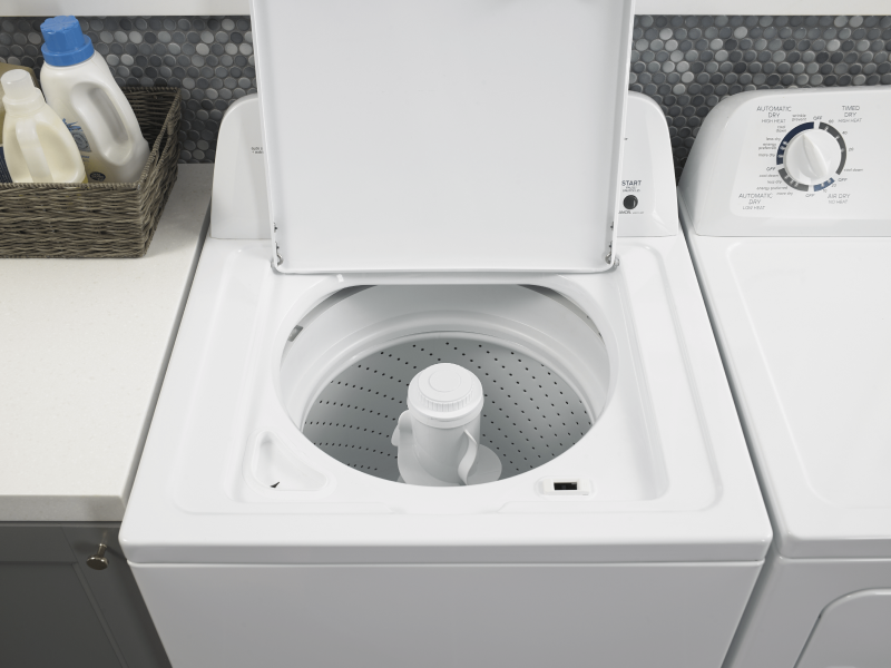 Open white top loading washer with an agitator