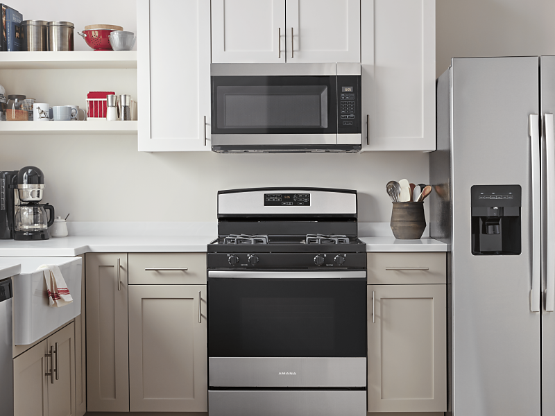 Amana® stainless steel kitchen appliances in a bright kitchen