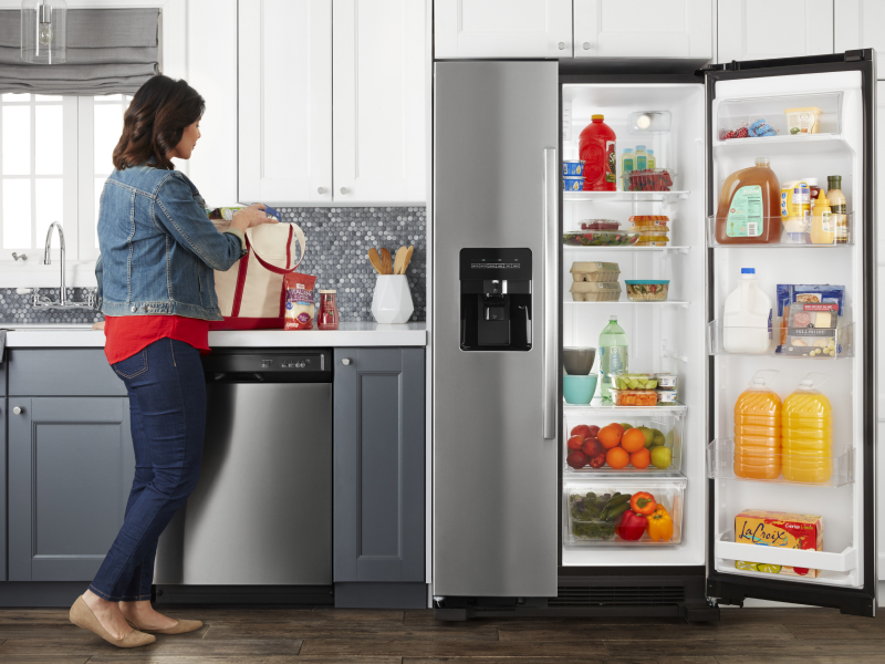 Amana® side-by-side refrigerator open on one side