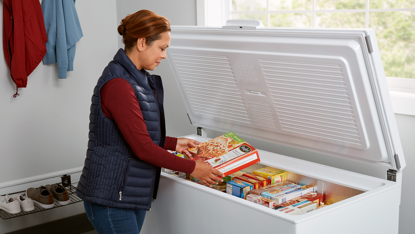  Person putting food in a chest freezer 