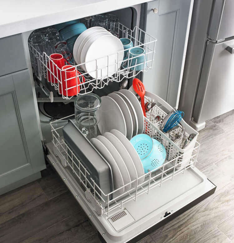 Amana® dishwasher loaded with dishes.