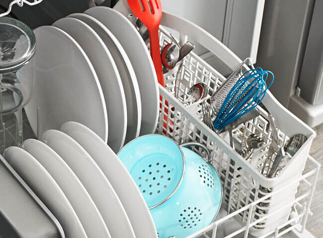 Amana® dishwasher loaded with dishes