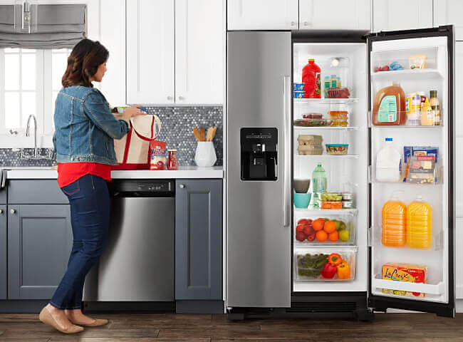 Amana® side-by-side refrigerator with door open