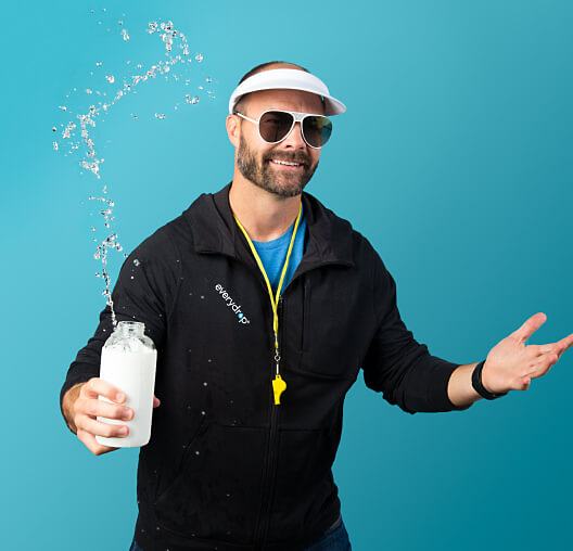 A man in sunglasses holding a glass water bottle.