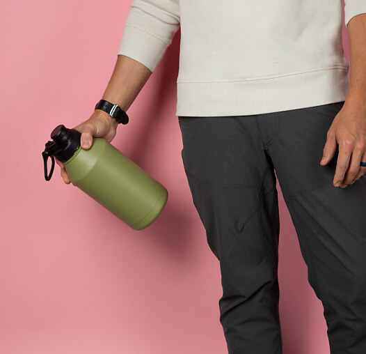 A man holding a metal water bottle.