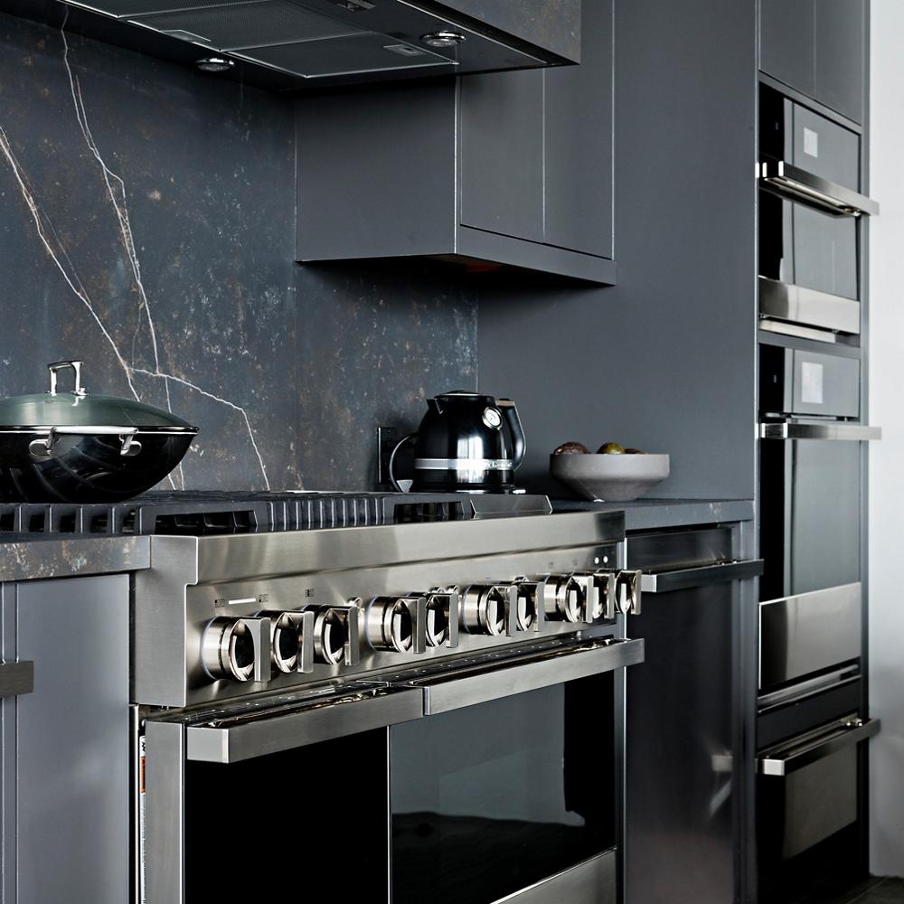 a luxury dark coloured kitchen with JennAir appliances