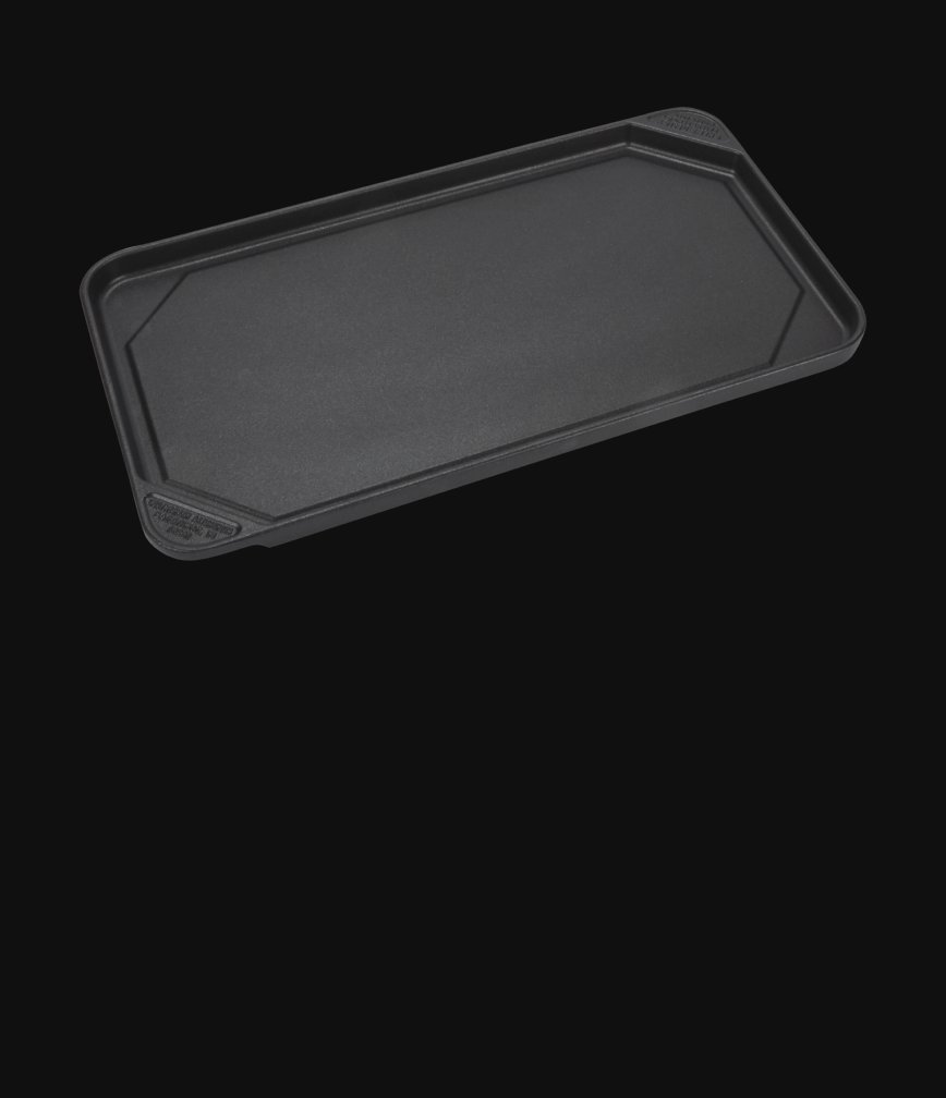 A griddle accessory isolated on a black background.