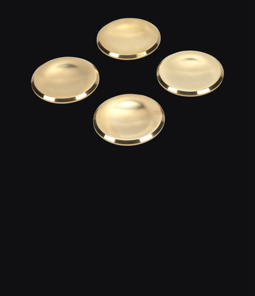 Brass burner caps isolated on a black background.