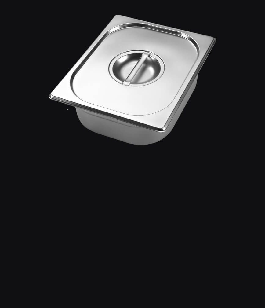 A warming pan with lid isolated on a black background.