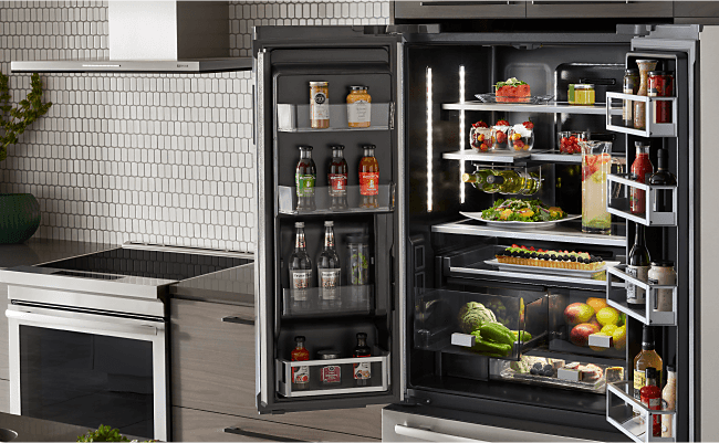 A fully stocked JennAir Freestanding Refrigerator in a sleek kitchen.