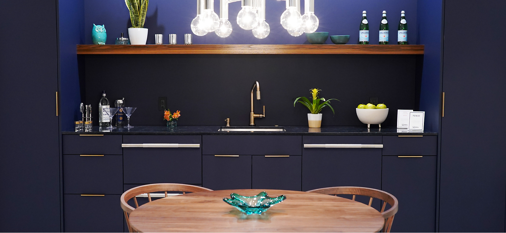 A small kitchen with navy blue cabinets. 
