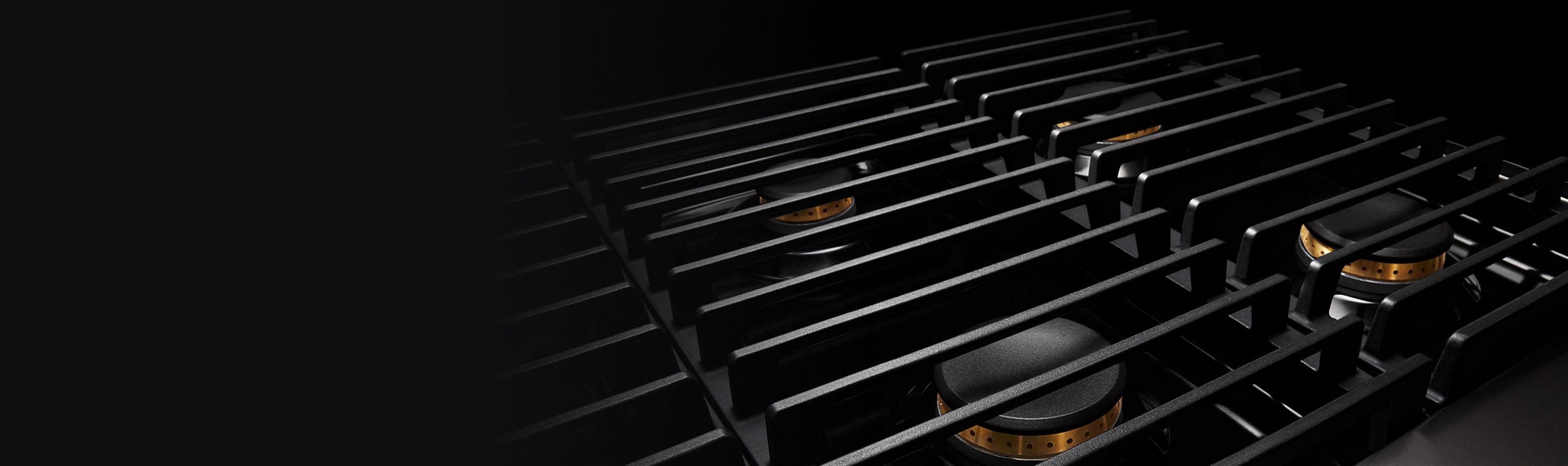 The cast iron grates of professional-style range, with brass detailing.