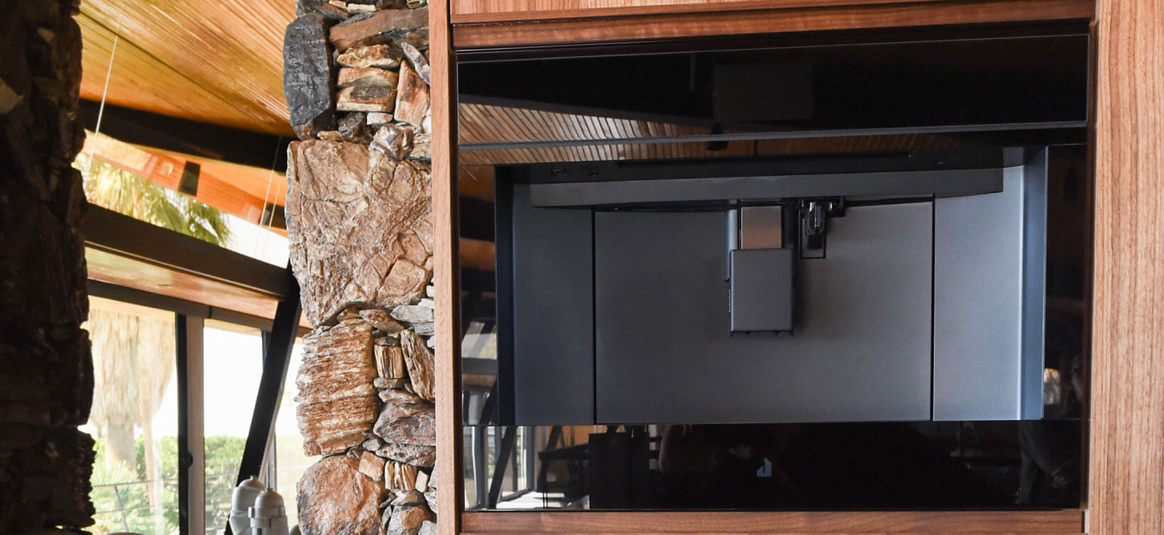 A JennAir Built-In Coffee Machine installed in a rustic, wooden home. 