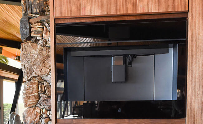 A JennAir Built-In Coffee Machine installed in a rustic, wooden home. 