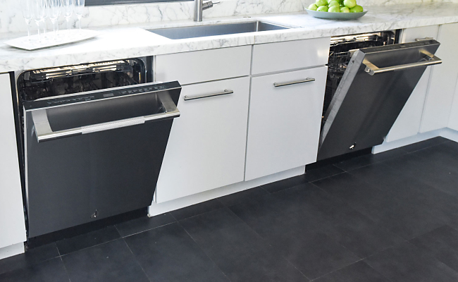 Two open JennAir Dishwashers in a bright white kitchen. 