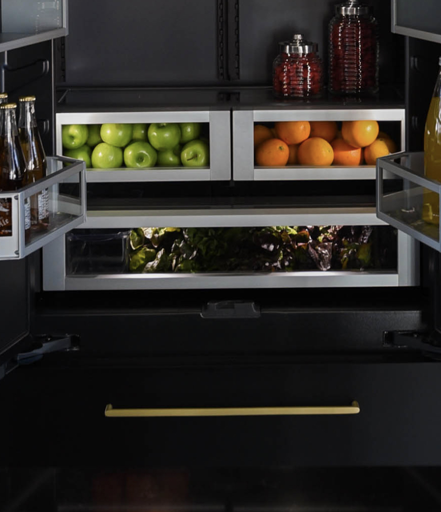 The interior of a JennAir® Built-In Refrigerator with the drawers filled with vibrant produce.