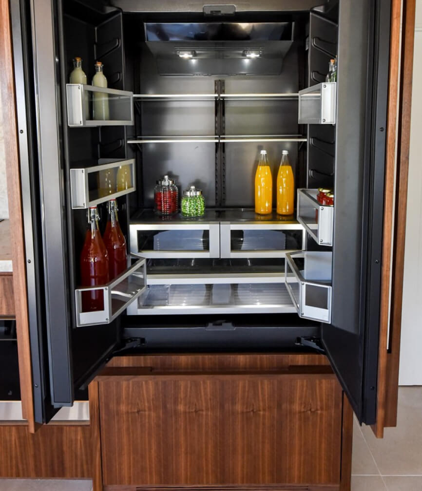 The lit Obsidian interior of a JennAir® Built-In Refrigerator.
