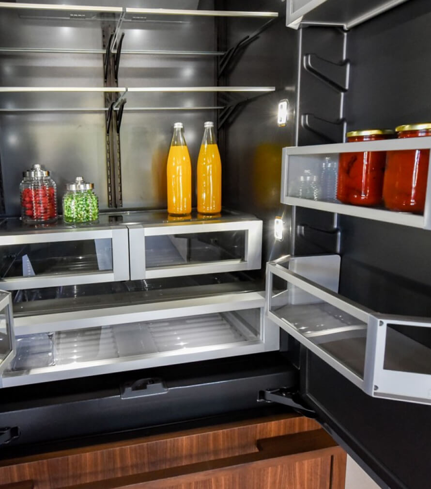 The interior of a JennAir® Built-In Refrigerator with LED theater lighting illuminating each corner of the shelving.
