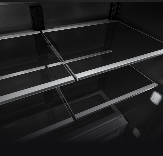 The glass and metal shelves in a JennAir® built-in refrigerator.