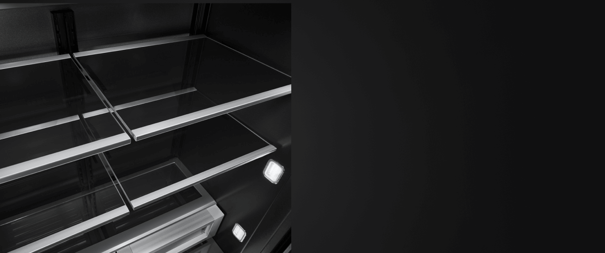 The glass and metal shelves in a JennAir® built-in refrigerator.