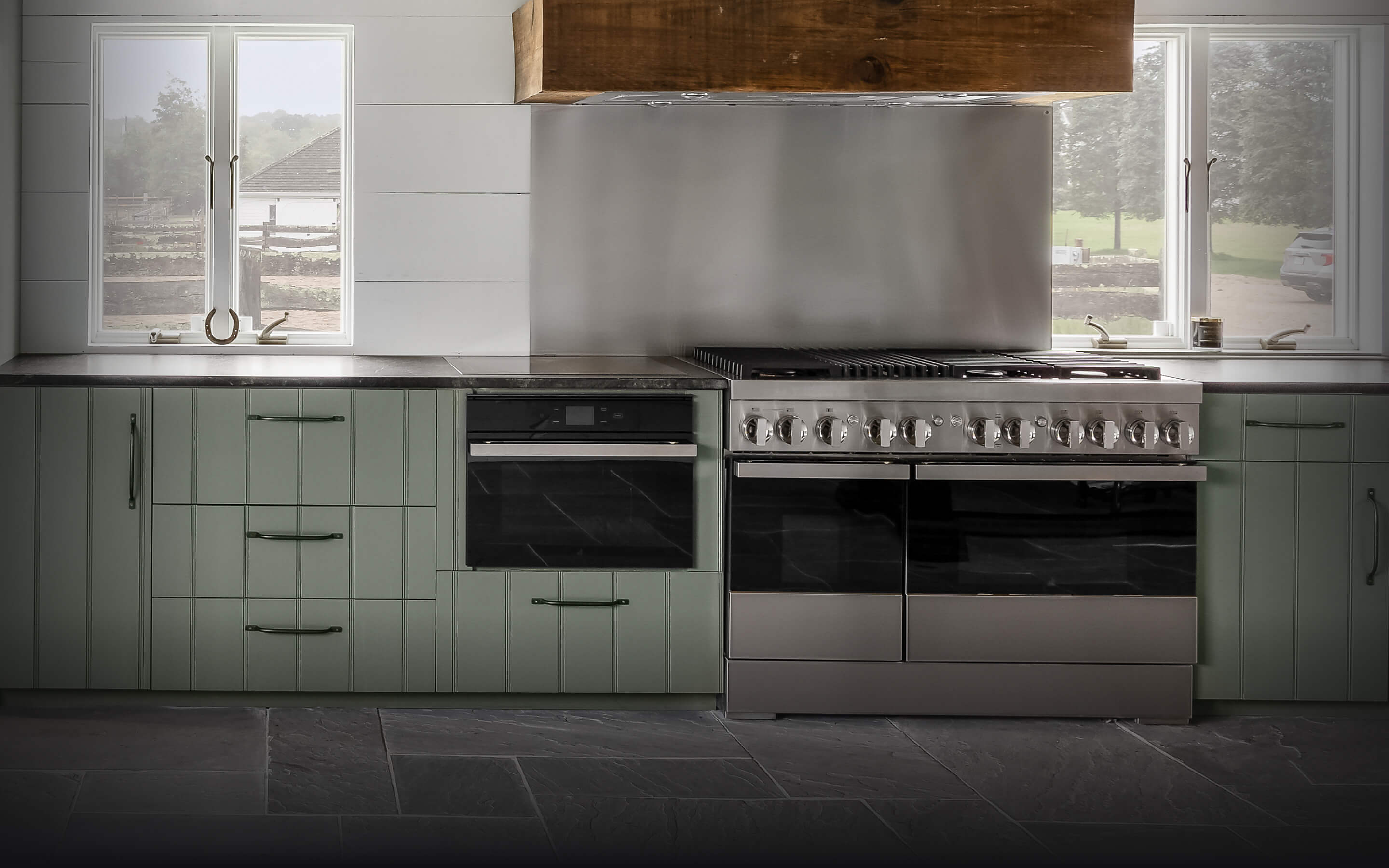 A JennAir® NOIR™ Dual-Fuel Range and Steam Oven in a high-end kitchen.