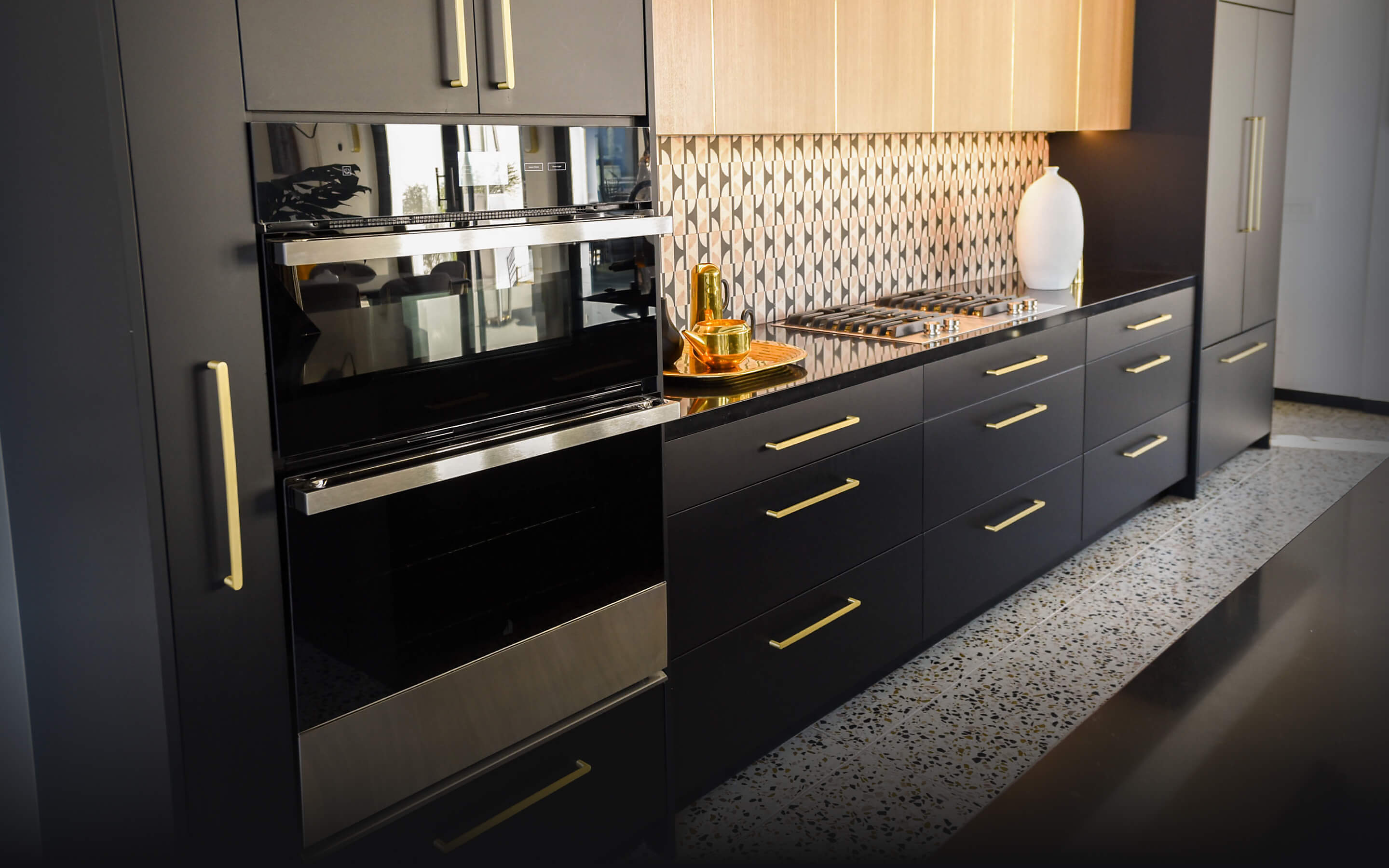 A JennAir® NOIR™ Microwave Combination Wall Oven in a modern kitchen with black cabinets.