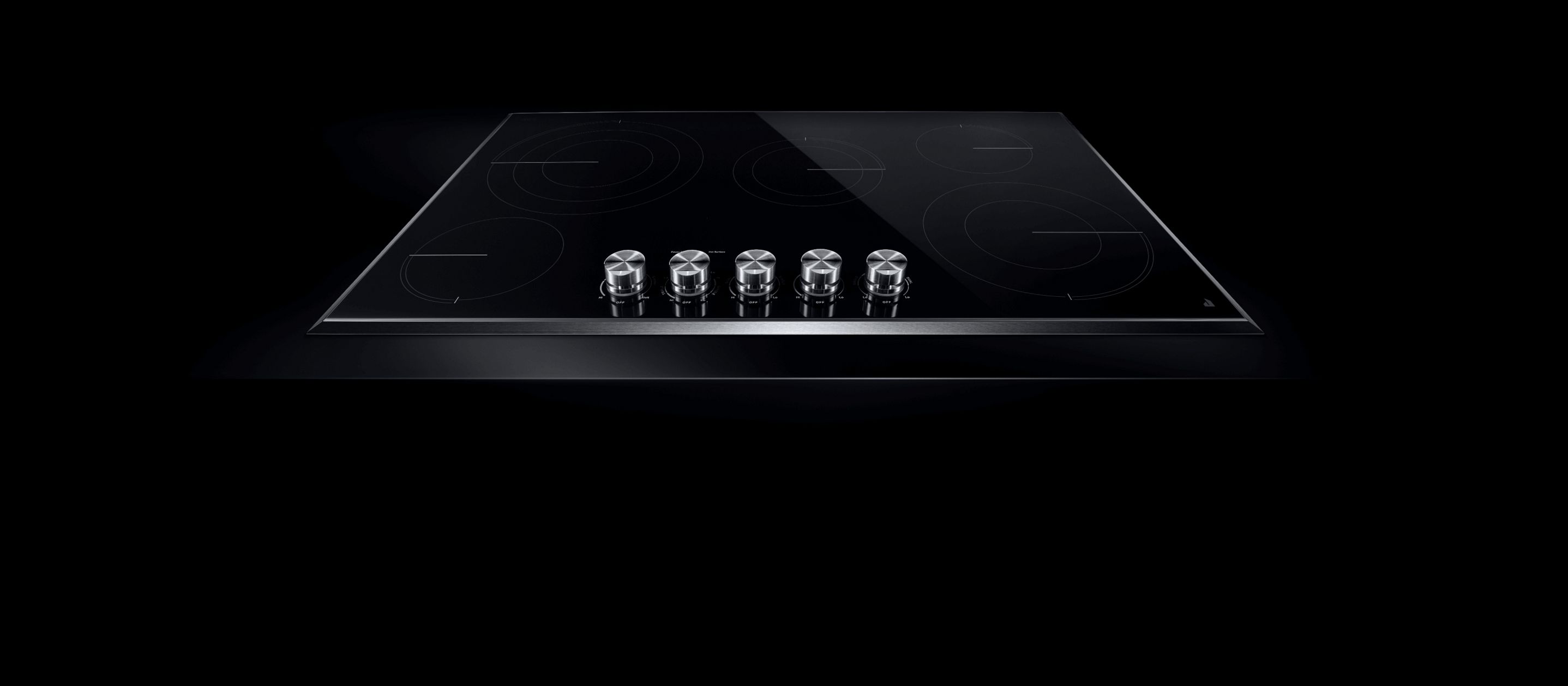 A JennAir® electric radiant cooktop with front knob controls.