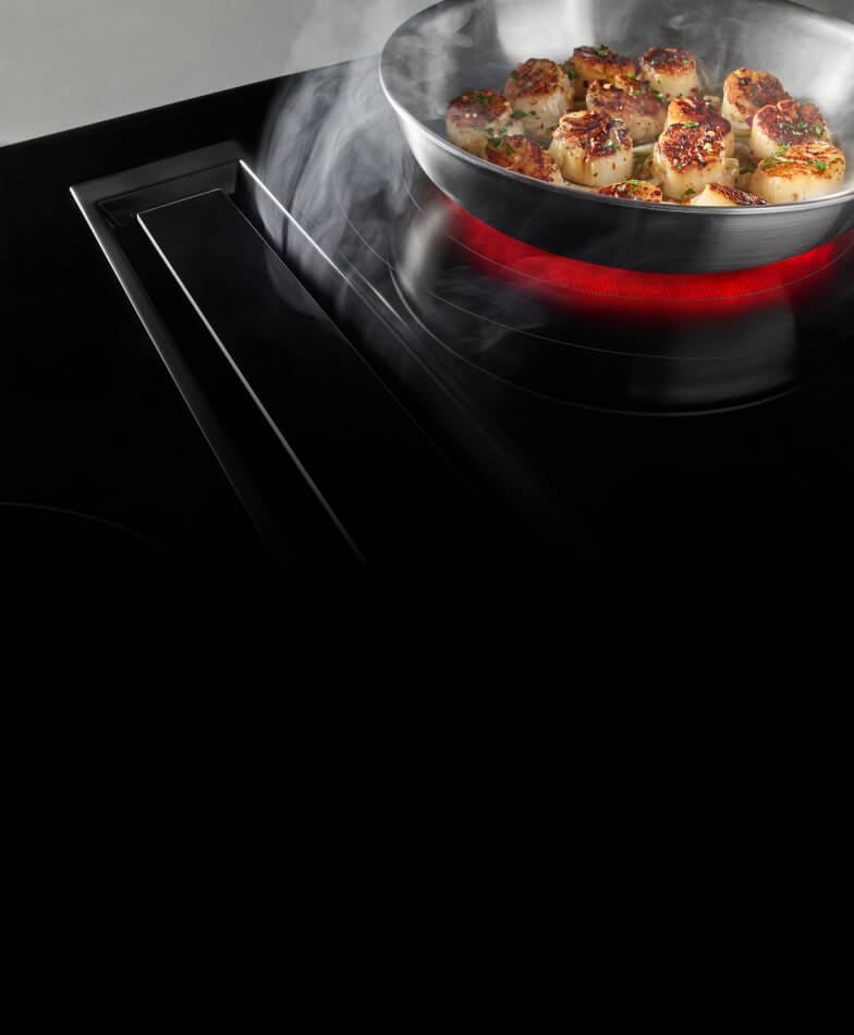 A JennAir® electric radiant cooktop with perimetric downdraft ventilation.