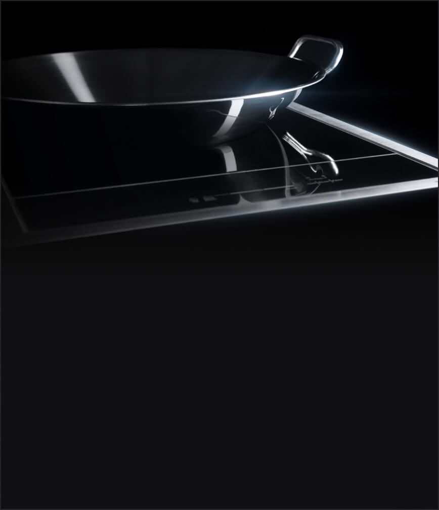 The 15-inch Induction Wok Cooktop with a stainless steel round wok fitting neatly in the concave element.