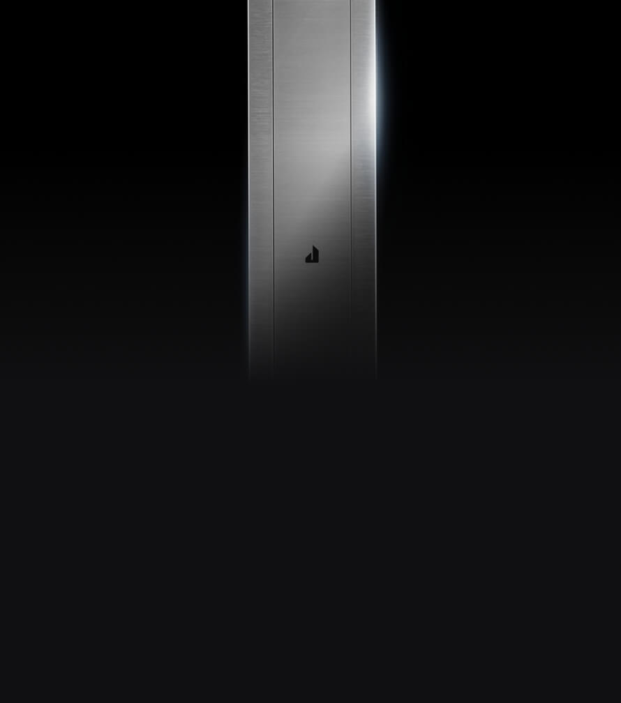 The sleek stainless downdraft vent isolated on a black background.