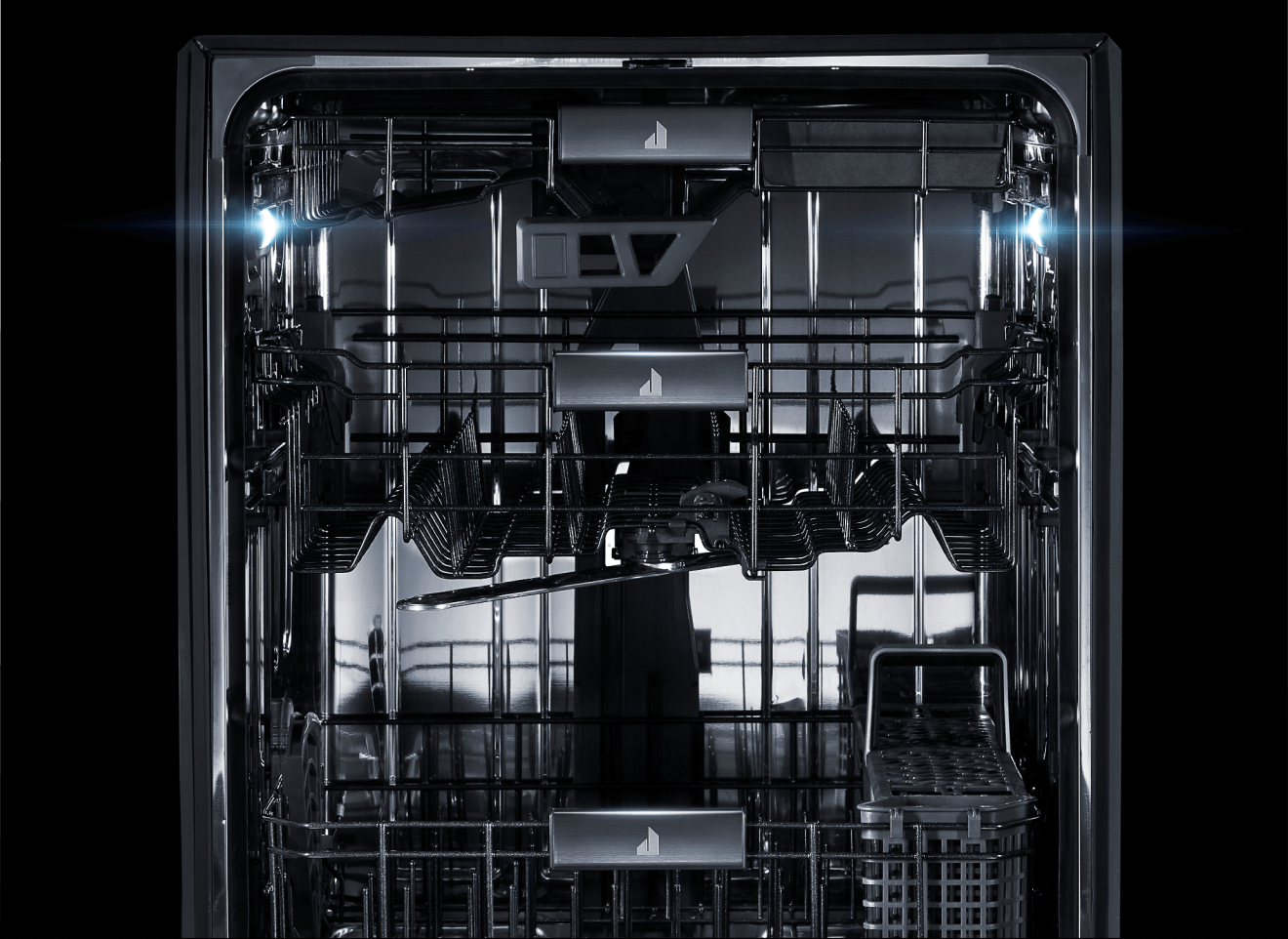 The interior of a JennAir® dishwasher, lit up and clearly visible.