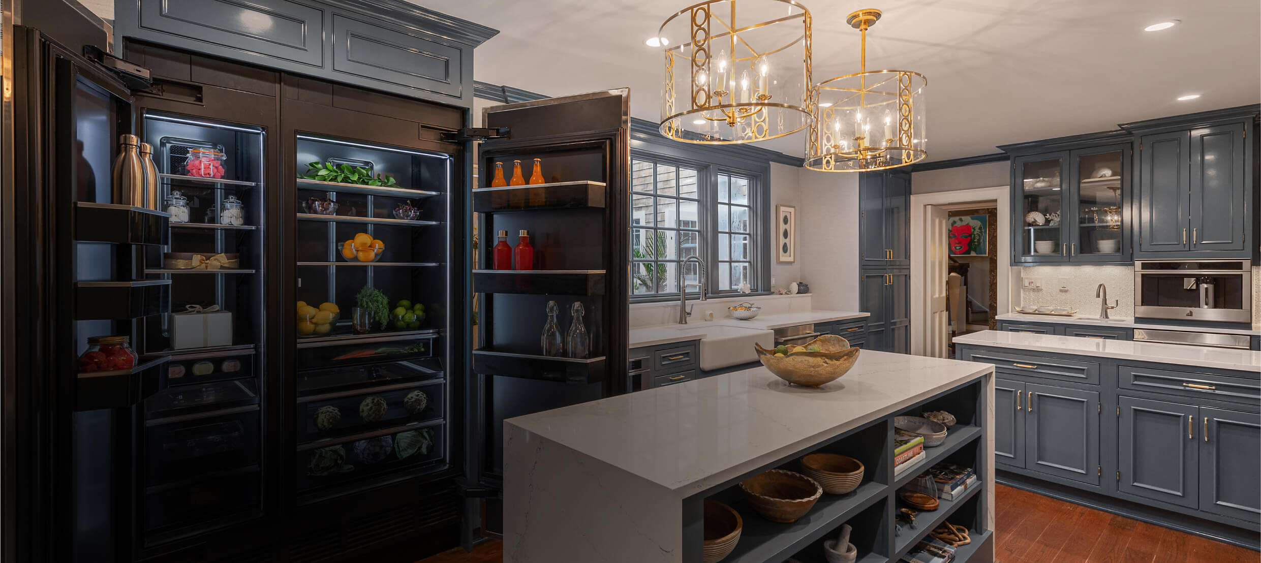 A beautiful blue kitchen with JennAir® appliances.
