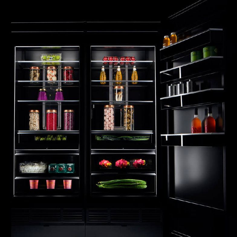 The interior of a JennAir refrigerator stocked with luxurious ingredients and fine foods. 