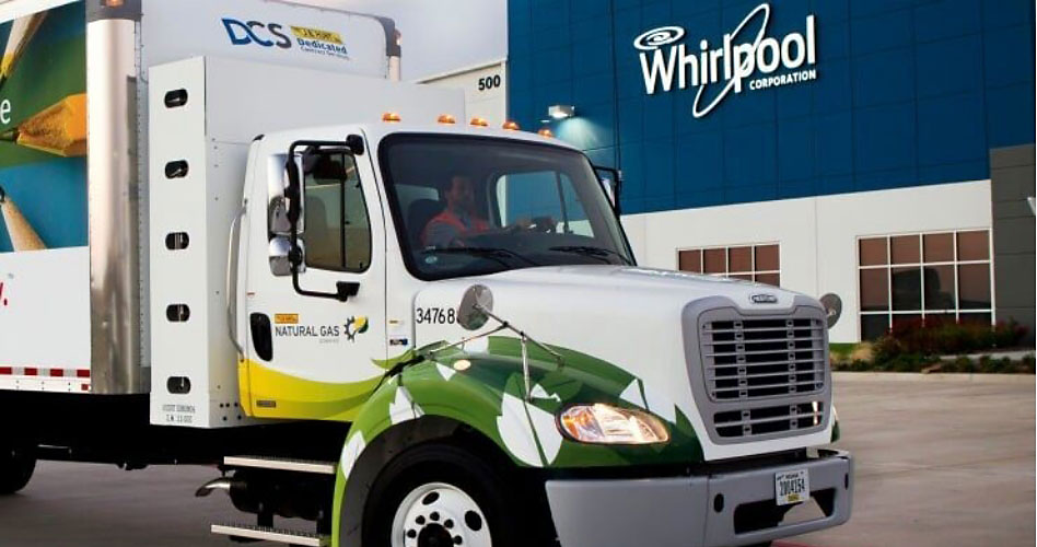 A truck in front of a building branded with the Whirlpool logo