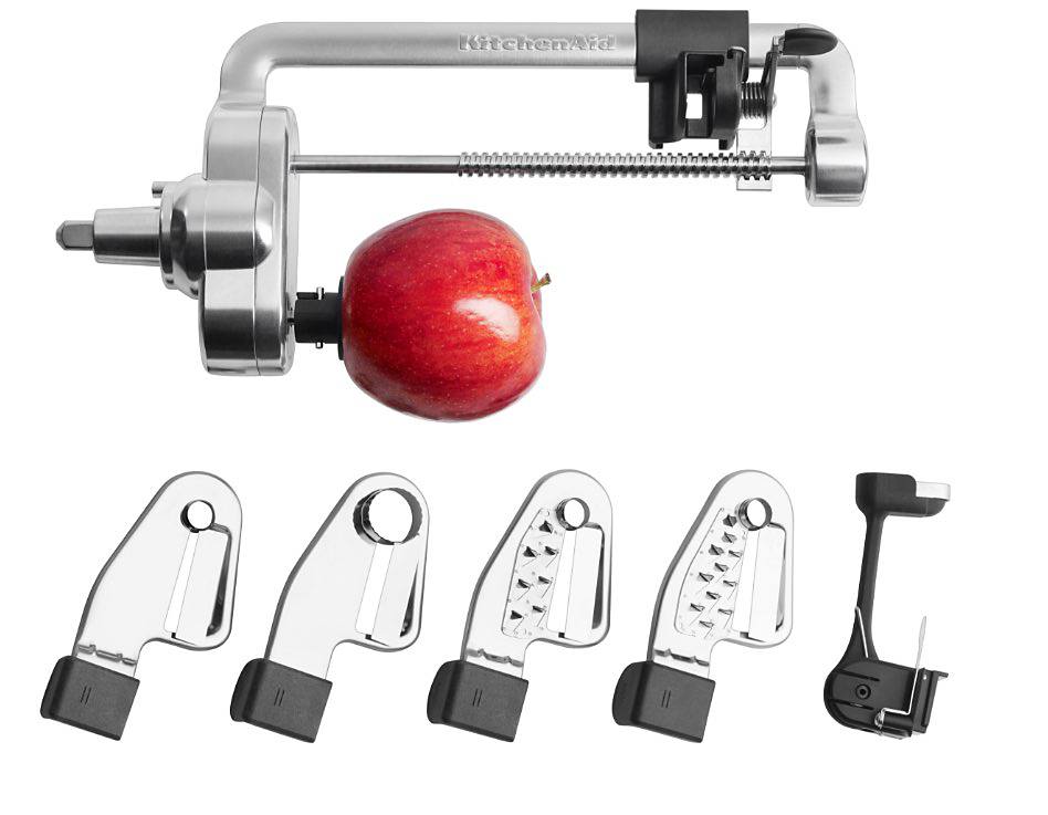 Stand mixer attachment with an apple attached that is about to be cored. Five different blades