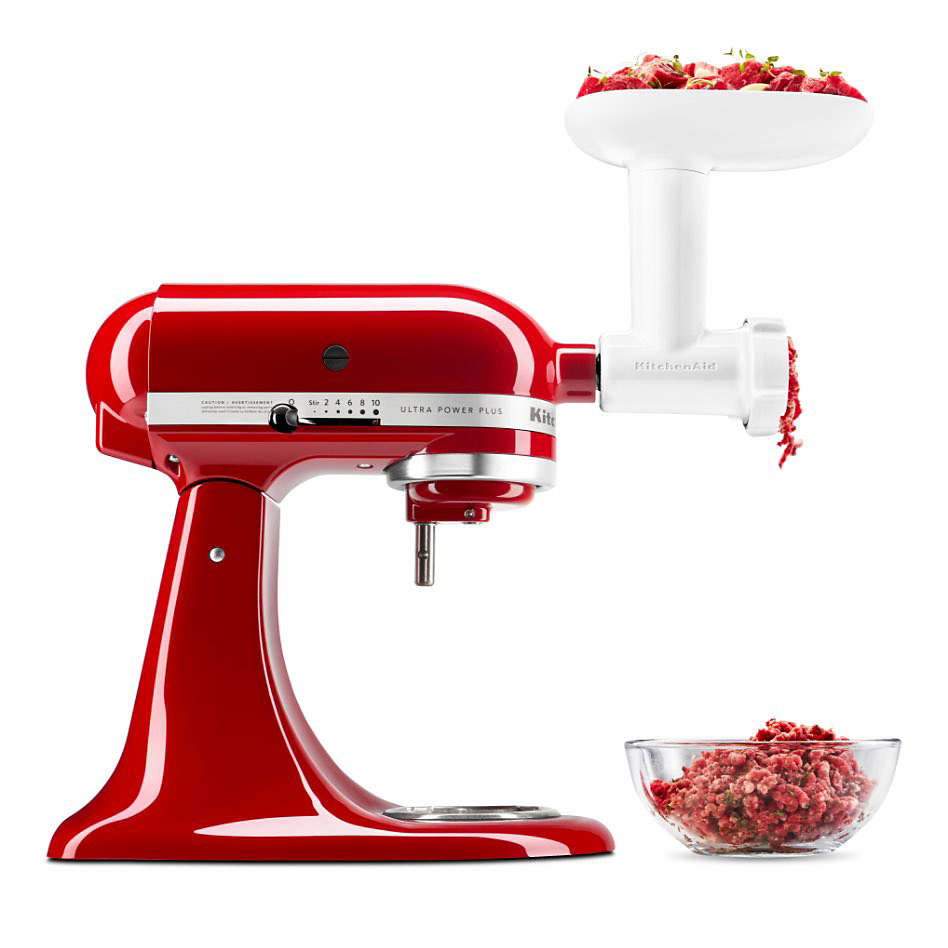 A KitchenAid Stand Mixer with a Meat Grinder Attachment that is grinding meat into a bowl