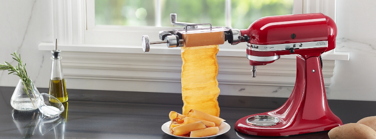 A red KitchenAid Stand Mixer with vegetable sheet cutter attachment is used to make vegetable sheets.