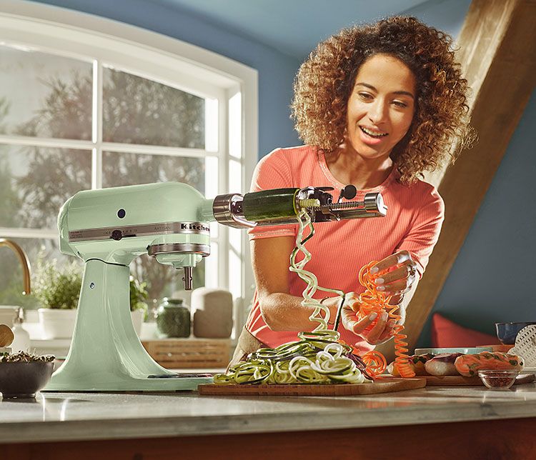 KitchenAid® Stand Mixer w/attachment making beet noodles.