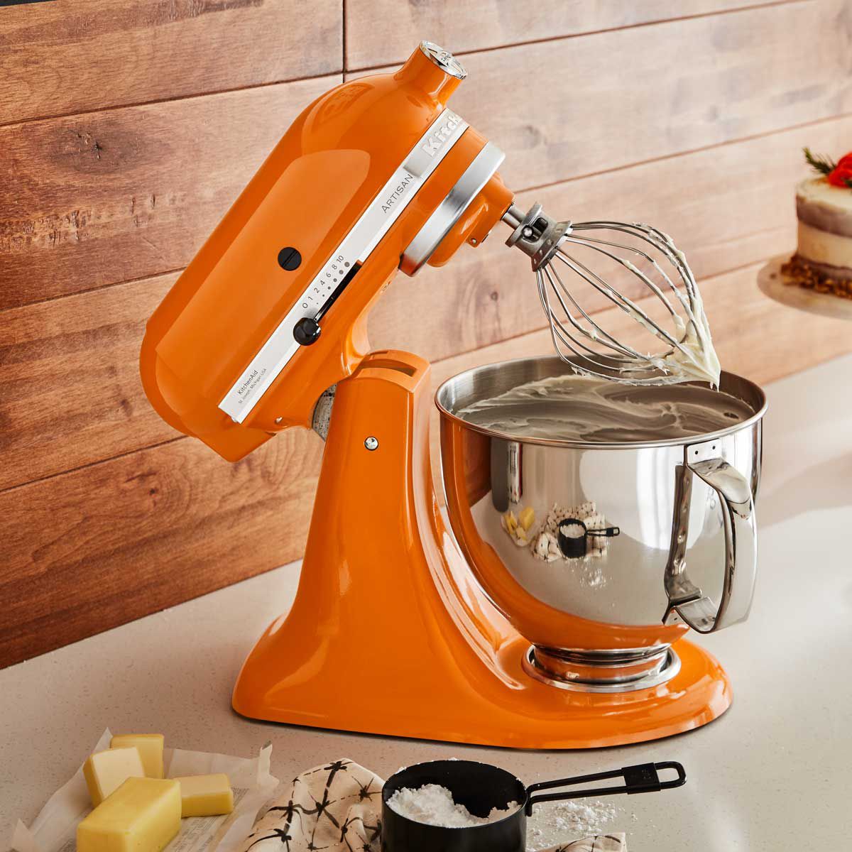 A honey coloured KitchenAid stand mixer on a counter