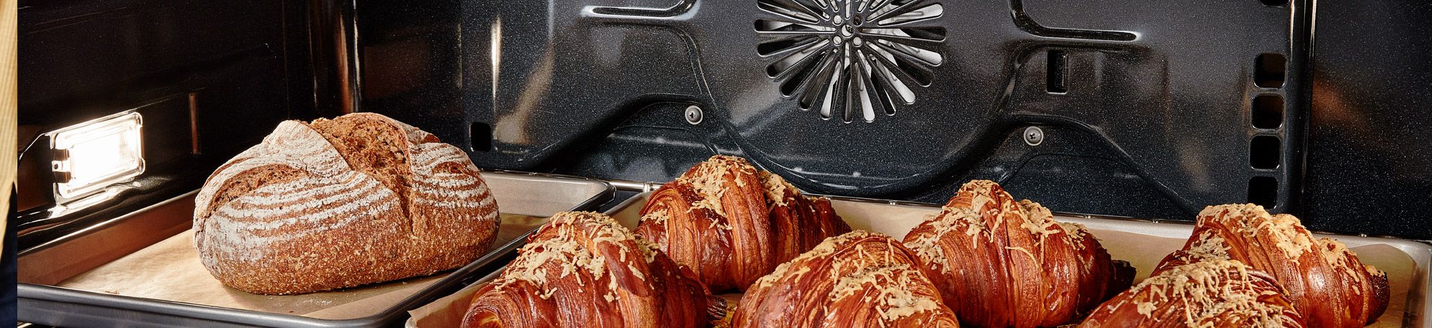 Cheese croissaints baking in a KitchenAid oven.