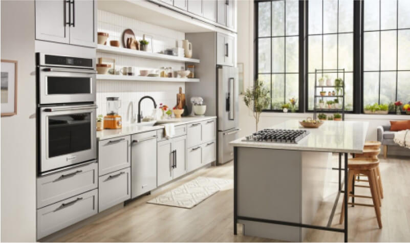 A bright white kitchen outfitted with KitchenAid® appliances.