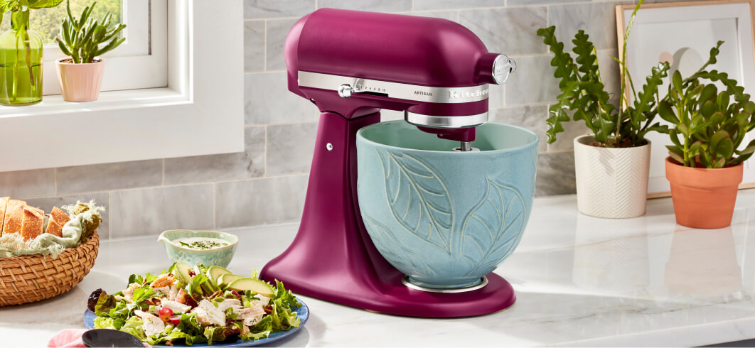 A beetroot KitchenAid® Stand Mixer with a teal printed leaf bowl.