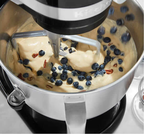 The interior of a KitchenAid® Bowl-Lift Bowl, folding fresh berries into dough.
