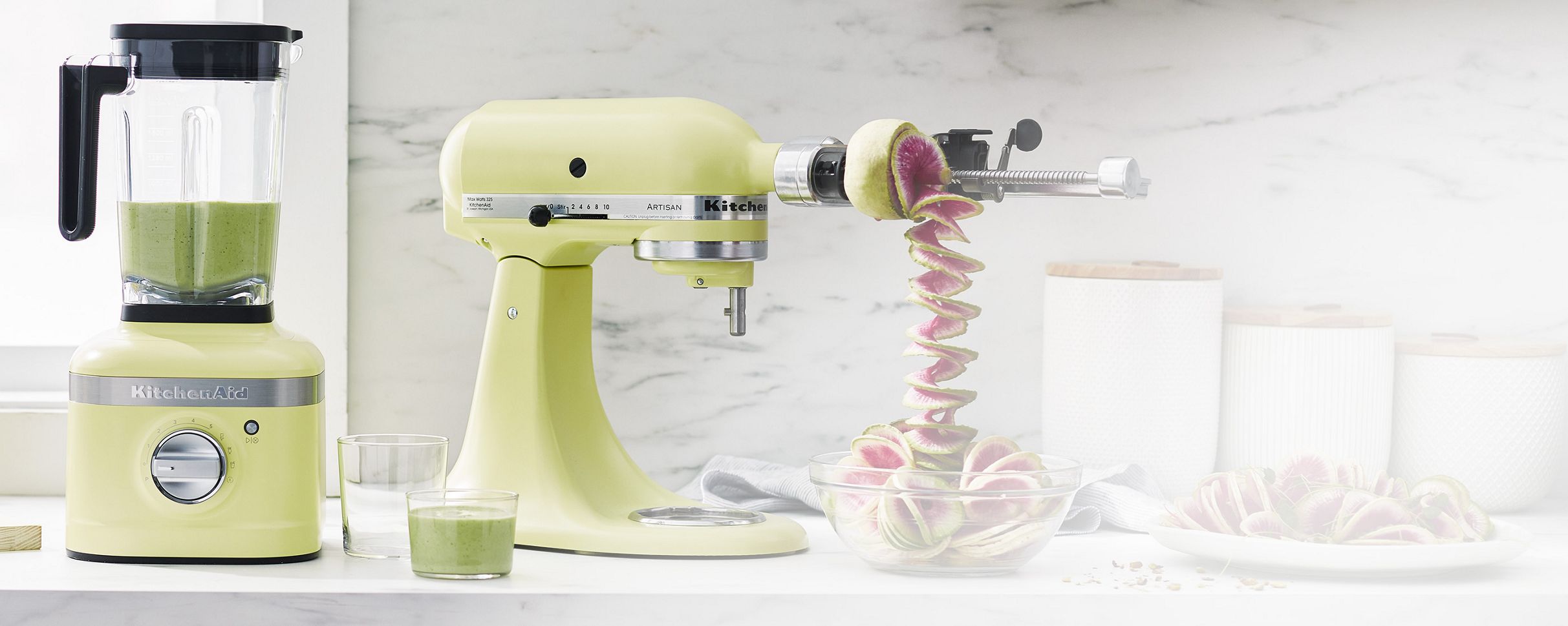A bright counter with a Kyoto Glow KitchenAid® Artisan® Series Stand Mixer and K400 Variable Blender.