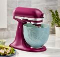 A KitchenAid® Stand Mixer in Beetroot with a 5 Quart Spring Leaves Ceramic Bowl.