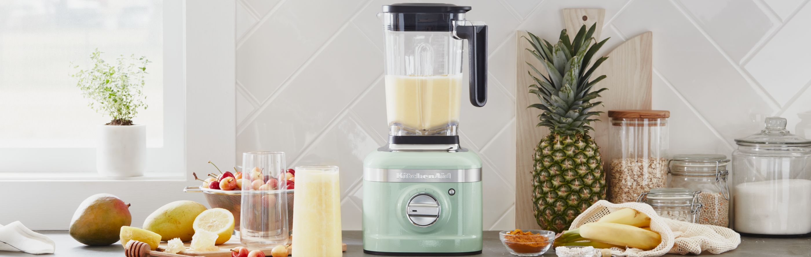 Mint green KitchenAid® countertop blender with surrounding ingredients
