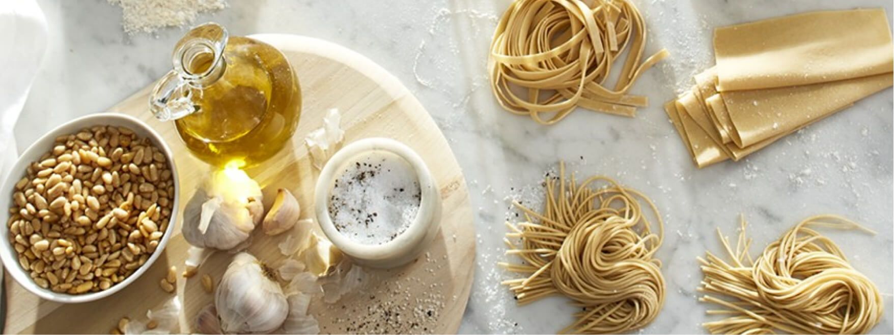 Homemade pasta nests and ingredients on a kitchen counter