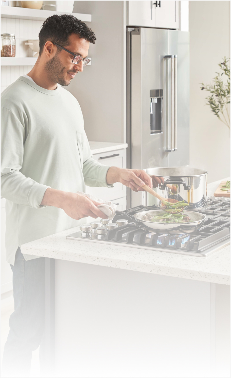 Man cooking on a gas cooktop 