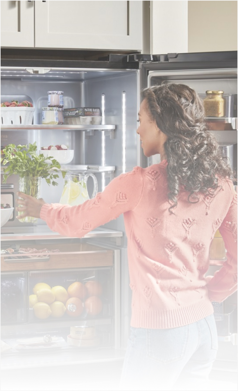Woman standing in front of an open refrigerator
